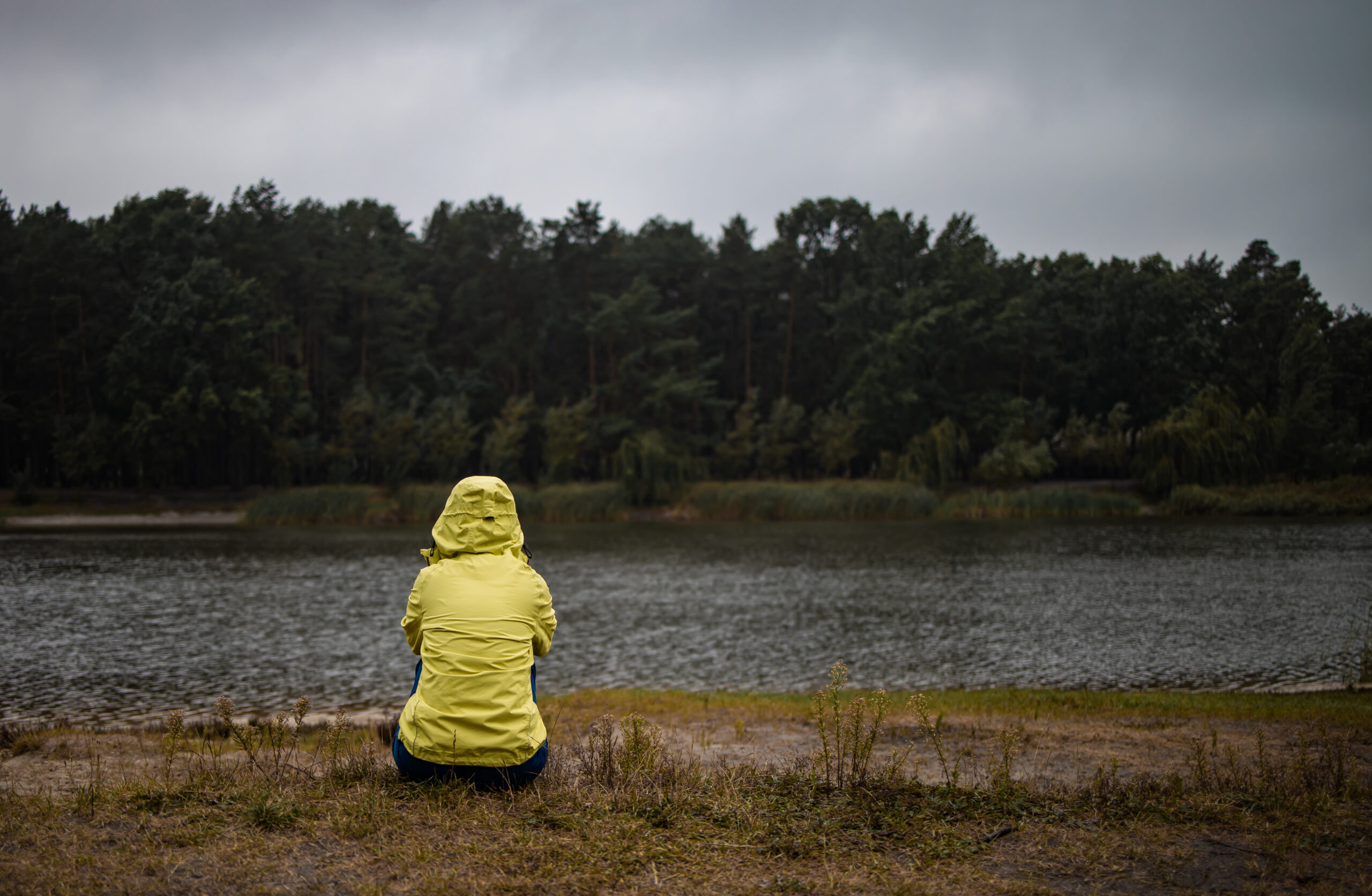 lonely-sad-woman-in-yellow-raincoat-in-forest-unde-2023-11-27-05-19-45-utc